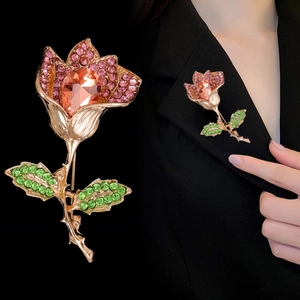 Sparkling crystal rose brooch with pink rhinestones on a black suit lapel