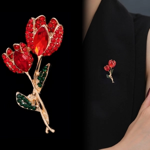 Luxurious tulip flower brooch with red crystals and green leaves on gold base
