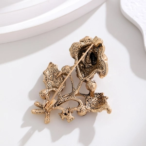 Vintage gold rose brooch with full diamond accents and secure safety pin closure