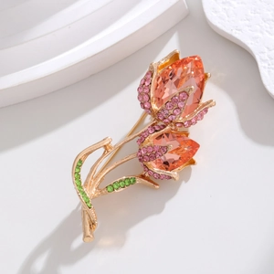 Detailed macro shot of tulip brooch with orange crystals and pink pavé rhinestones