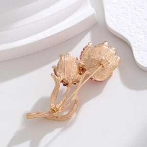 Elegant gold tulip brooch with pink rhinestones and brushed metal back detail