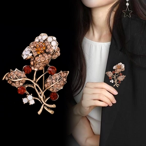 Vintage floral brooch with sparkling rhinestones pinned on a black suit jacket lapel