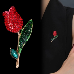 Elegant tulip brooch with red rhinestones and green leaves on a black blazer lapel