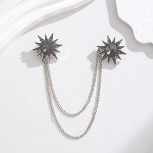 Detail view of vintage star pins with cascading silver chains and grey crystals