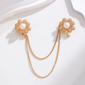 Detail of gold clover brooches with pearls, rhinestones and elegant layered chains