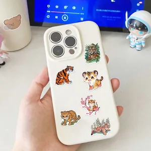 Detailed view of colorful tiger theme stickers applied to a white smartphone case surface