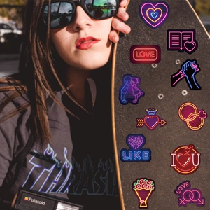 Skateboarder displaying neon Valentine stickers with romantic love motifs and heart designs
