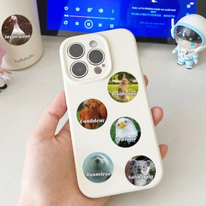 Detailed close-up of white phone case featuring six creative motivational animal stickers