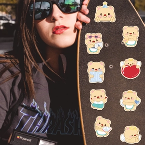 Close-up of cute cartoon bear stickers in various poses on a stylish skateboard
