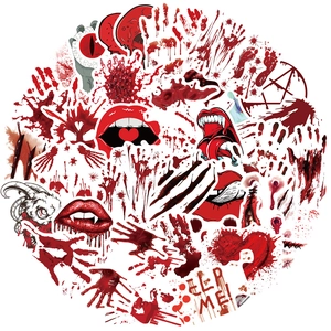 Macro shot of Halloween horror stickers featuring bloody handprints and vampire fangs
