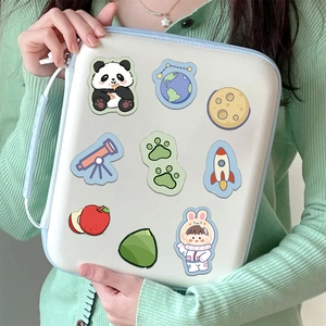 Close-up of white protective laptop sleeve featuring cute cartoon animal stickers and blue handle