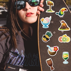 Detail shot of tropical summer graffiti stickers featuring Aloha signs on a skateboard