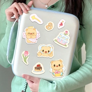 Cute Butter Bear stickers applied on a white digital storage bag held by a person