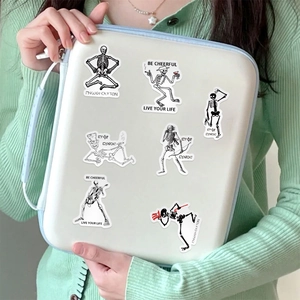 Skeleton themed waterproof stickers on laptop sleeve with Greek mosaic art style