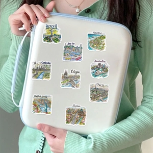 Hand-drawn world travel stickers featuring famous landmarks on a white handbag