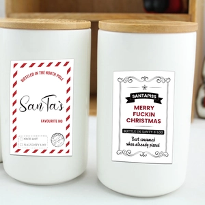 Set of two white ceramic jars with bamboo lids and funny Christmas wine label stickers