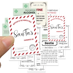 Close-up of PVC waterproof wine stickers with creative Christmas quotes and red borders