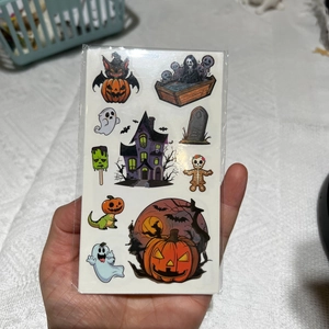 Close-up of Halloween cartoon stickers with pumpkin, ghost, and bat patterns on a sheet