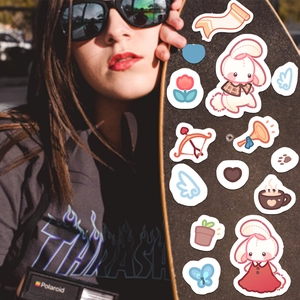 Cute cartoon bunny collage stickers for scrapbooking applied on a trendy skateboard