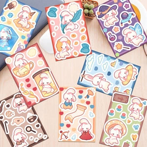 Variety of cute cartoon rabbit stickers scattered on a wooden desk with a cozy lifestyle vibe