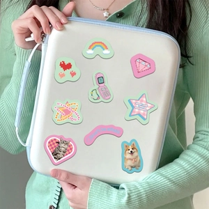 Close-up of cute pixel art cartoon stickers on laptop cover with PVC waterproof material