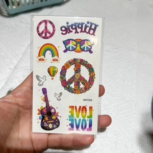 Detail view of hippie peace love temporary tattoo stickers for face and body party decor