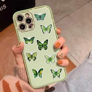 Close-up of green butterfly phone case on iPhone with stylish fashion nails