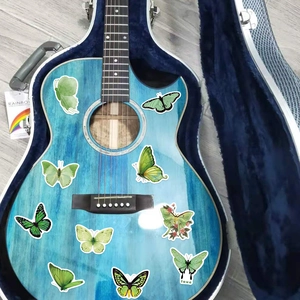 Detail of green butterfly PVC stickers decorated on a blue guitar for a creative scrapbook look