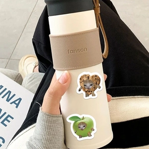 Insulated white tumbler with leather sleeve featuring cute creative cat head stickers