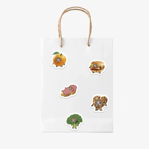 Detailed view of white paper gift bag featuring five creative cute cartoon cat stickers