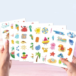 Hand holding vibrant summer cartoon stickers set featuring ocean animals and beach themes