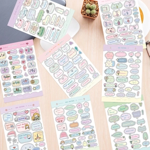Flat lay of colorful macaron sticker sheets for journals featuring holiday and date icons