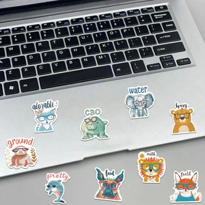 Detailed close-up of cute cartoon animal stickers displayed on a silver laptop surface