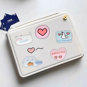 Close-up of shockproof white laptop sleeve with cute cartoon prints and flower pendant