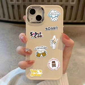 Close-up of colorful Sober sobriety stickers applied on an off-white phone case surface