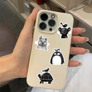 Detail of cute animal stickers on a beige iPhone case featuring black and white illustrations