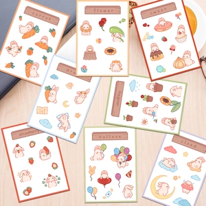 Flat lay of rabbit themed aesthetic stickers on a wooden desk with a coffee cup