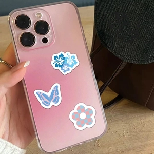Blue aesthetic stickers on a gradient phone case featuring floral and butterfly motifs