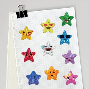 Roll of colorful glitter star emoji stickers with assorted cartoon expressions on white paper