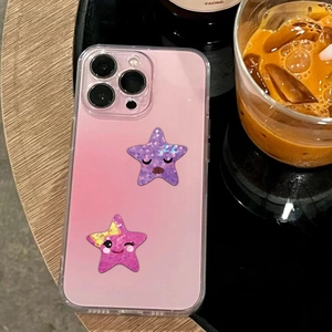 Detail of pink gradient phone case featuring cartoon star stickers on a black table