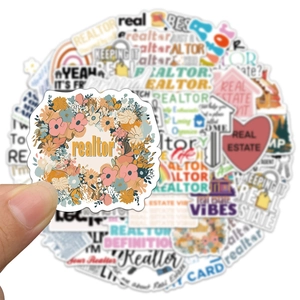Close-up of waterproof vinyl realtor stickers with floral designs and houses