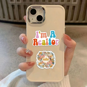 Close-up of Realtor stickers on a cream phone case with decorative 3D nail art holding it