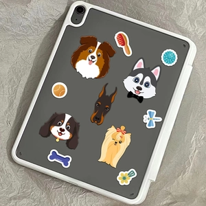 Detailed view of cute cartoon dog stickers on a tablet with husky and puppy designs
