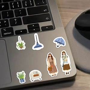 Detail of cute ins-style stickers on a laptop featuring plants, girls, and motifs