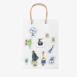 Detail of cute hand-drawn lifestyle stickers applied on a white paper bag for decoration