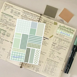 Set of green plaid and checkered aesthetic stickers for journals on a notebook