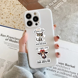 Funny animal stickers on white iPhone case featuring a grumpy cat and cartoon cow stickers
