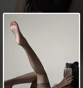 Detail shot of sheer black thigh high stockings with four horizontal decorative stripes