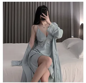 Close-up of light blue silk pajama set featuring floral lace details and a matching robe
