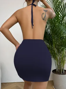 Detail of deep blue backless halter top and matching bodycon skirt showing slim fit design